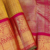 Sumangala - Golden mustard and rani pink handwoven Kanchipuram silk saree with zari checks and border