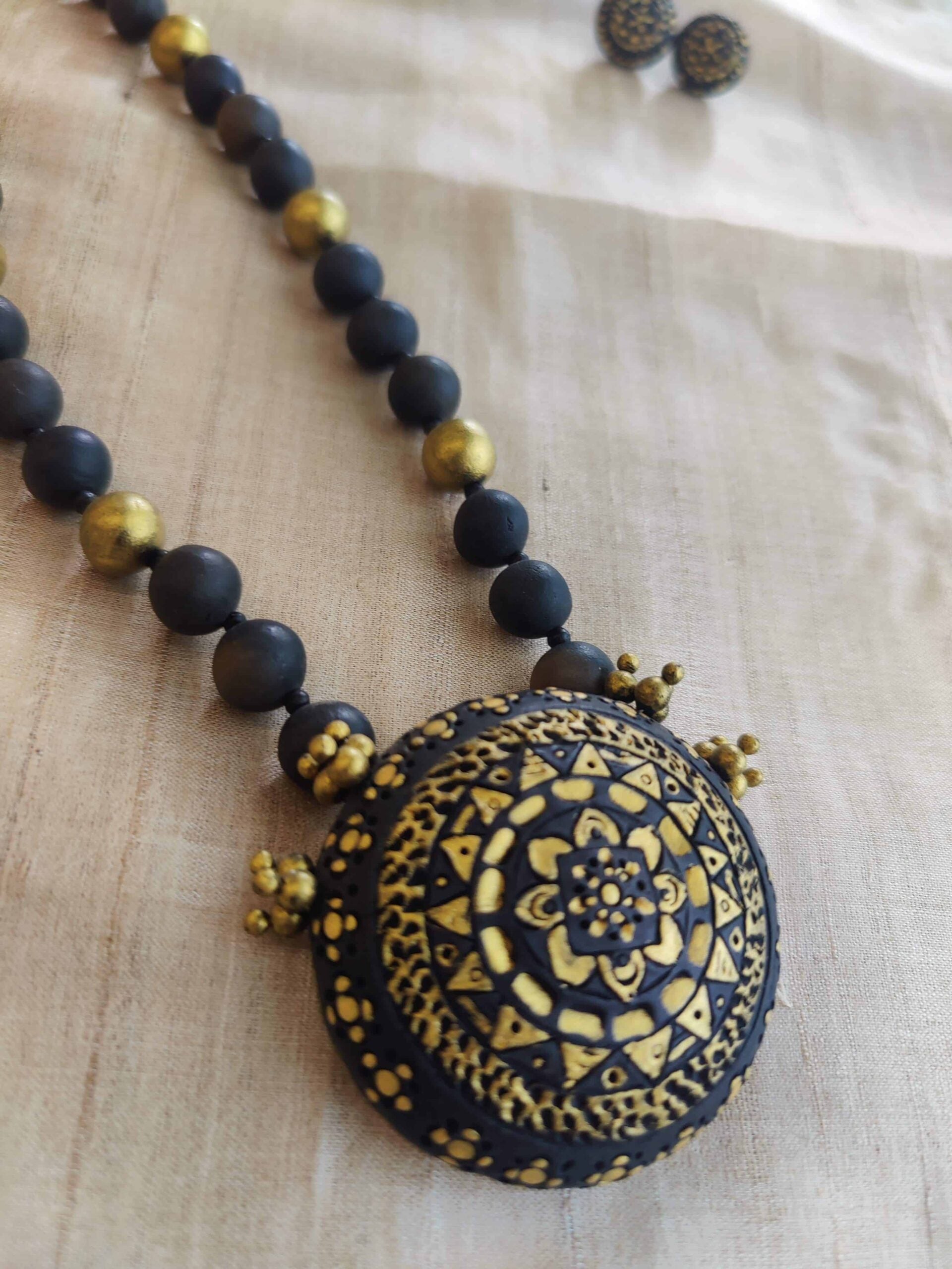 Black-and-gold-handmade-terracotta-beaded-necklace-with-pendant-and-tops-1-1.jpg