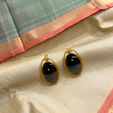 Oval brass earring