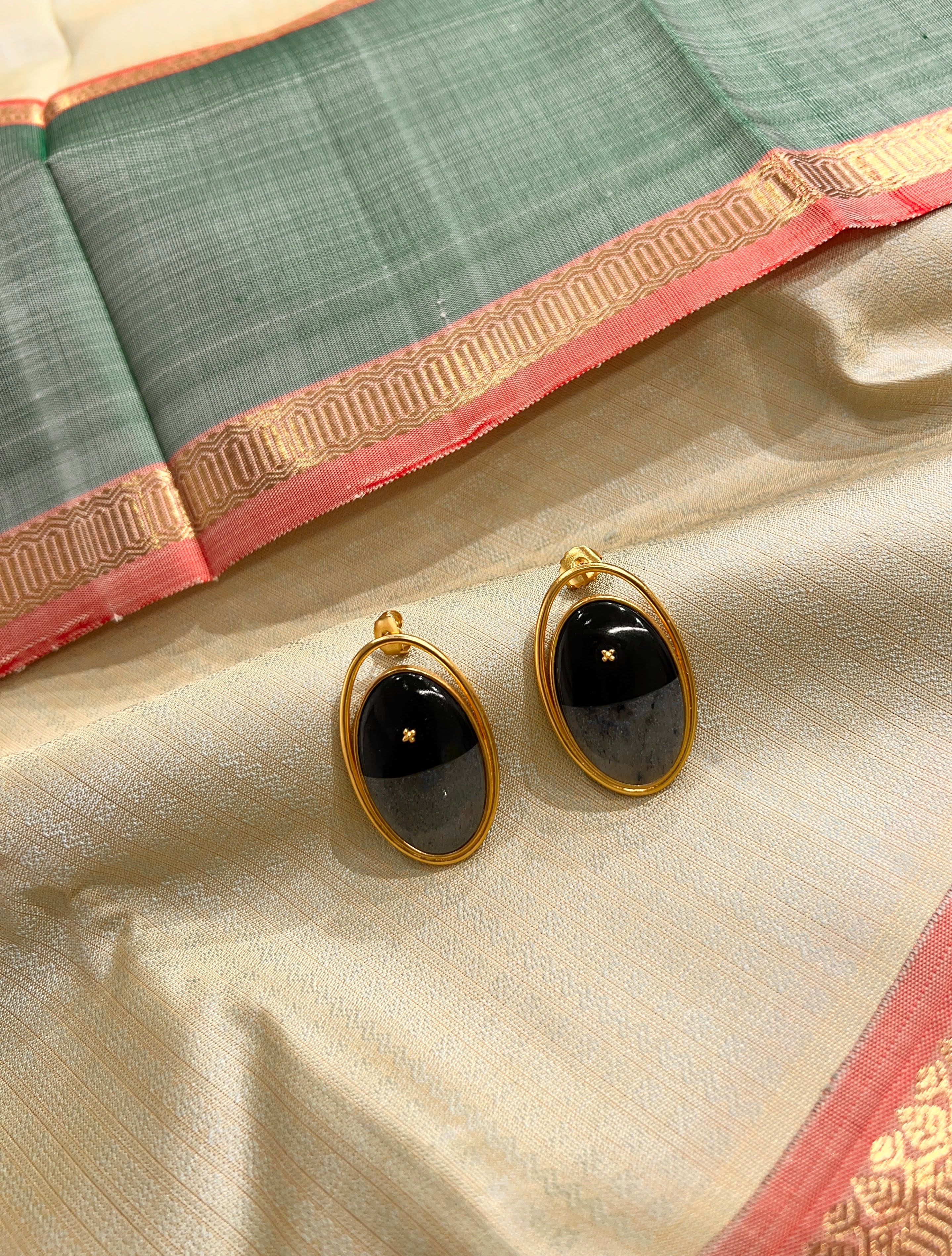 Oval brass earring