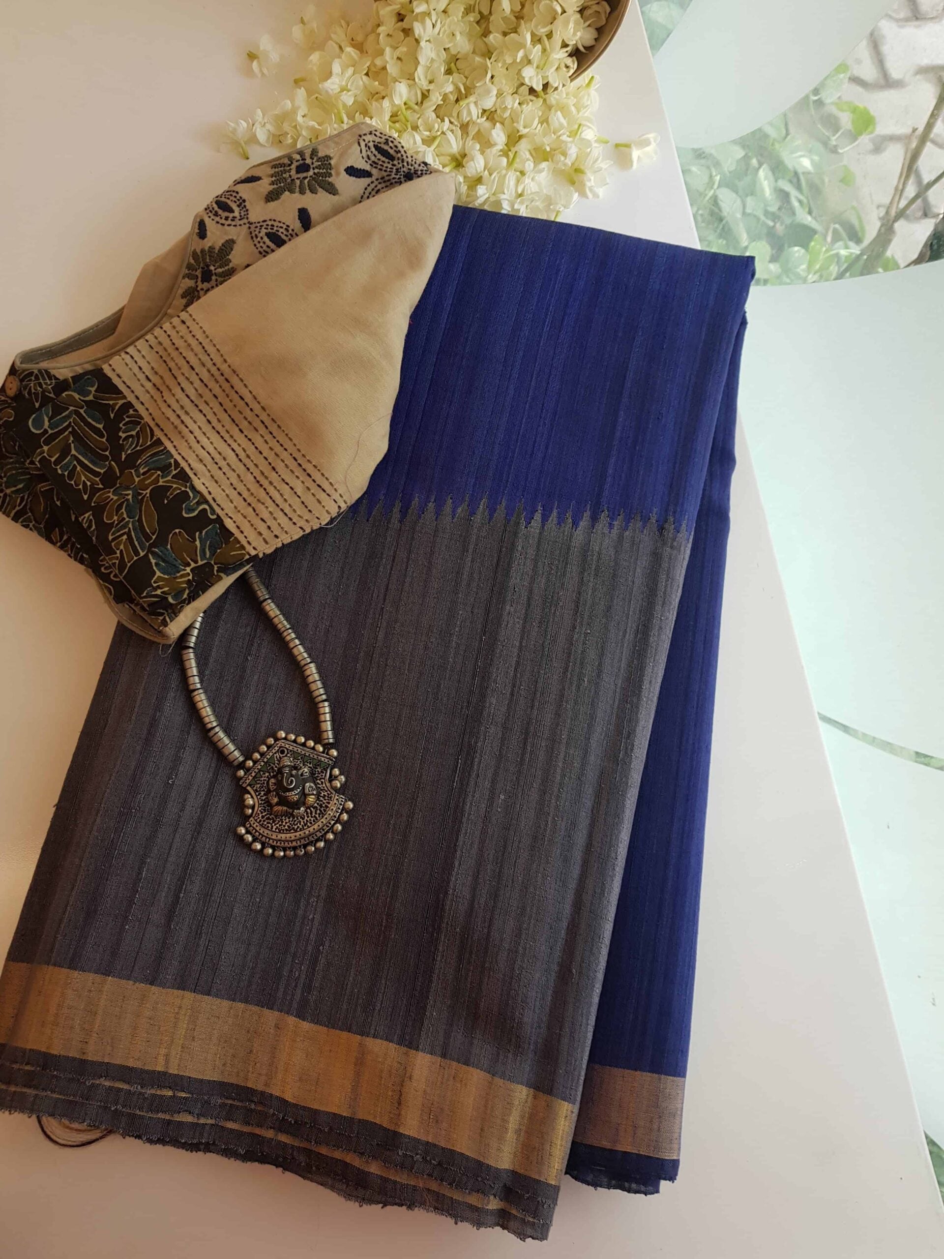 Royal-blue-and-grey-Matka-silk-saree-in-raising-pattern-with-zari-border-and-pallu.jpg