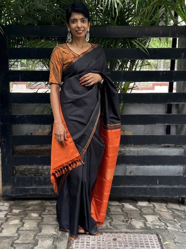 Lavanyam - black Kanchipuram silk saree with orange simple pallu