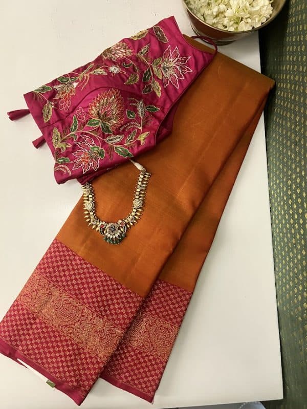 Orange pink kanchipuram silk saree with intricate border